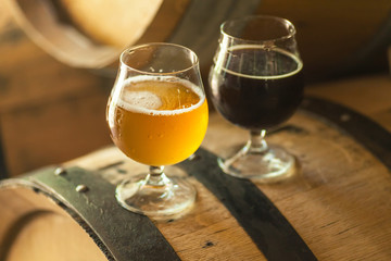 Dark and light beer on a barrel