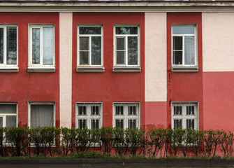 Fototapeta na wymiar The old Soviet two-storey building of red color
