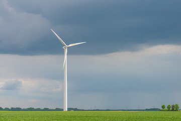 Fototapeta premium Wind turbine in a field in spring