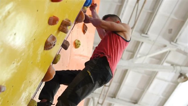 Man Climbing Up On Practice Wall Indoor