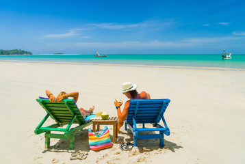 Mature Couple Relaxing in Deck Chairs on Tropical Beach