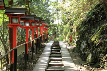 Red lanterns and stone steps at Kurama temple in Kyoto, Japan