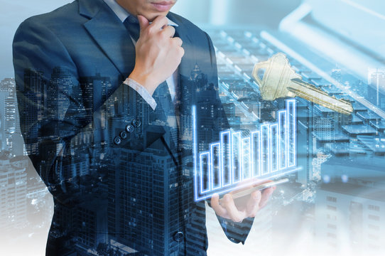 Double exposure of professional businessman hold and analyze smart phone with cityscape and financial / trading graph in Business trading and technology concept