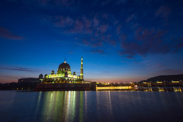 PUTRAJAYA, MALAYSIA - 9TH APRIL 2017; Sunrise moment at Putra Mosque, a principal mosque of Putrajaya, Malaysia. Construction of the mosque began in 1997 and was completed two years later.