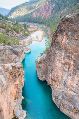 Fototapeta na wymiar Mountain stream full of smooth rocks in Yerkopru Canyon in Turkey