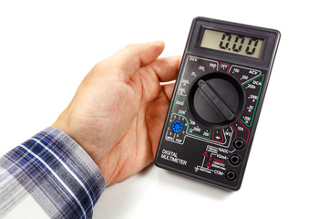 Digital multimeter in man's hand on a white background