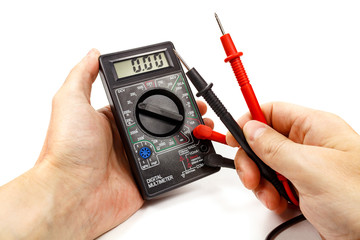 Digital multimeter with probes in man's hand on a white background