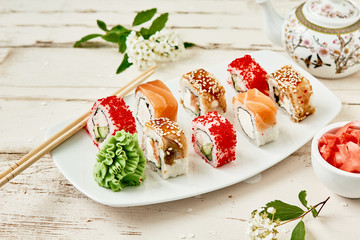 Sushi Set maki on white plate.Chopsticks, ginger and wasabi