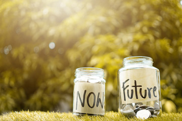 Money saving,  Coins inside Glass jar For now and future money. Concept of saving money for future. - 154553148