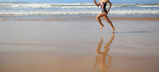 Fototapeta na wymiar young fitness woman wear swimsuit running on beach