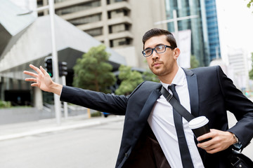 Young businessman hailing for a taxi