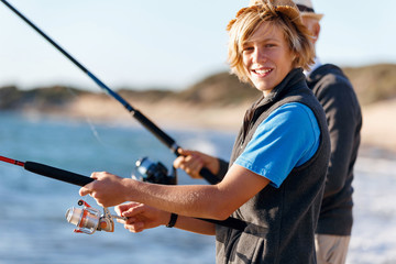 Senior man fishing with his grandson