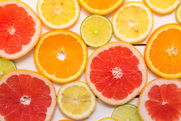 Citrus fresh fruits on the wooden white table. Top view