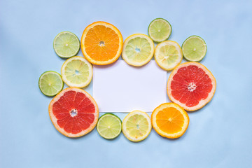 Fototapeta na wymiar Citrus background with copy space. Citrus fruits on the blue background with copy space. Top view