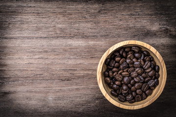 coffee beans isolated on wood background.