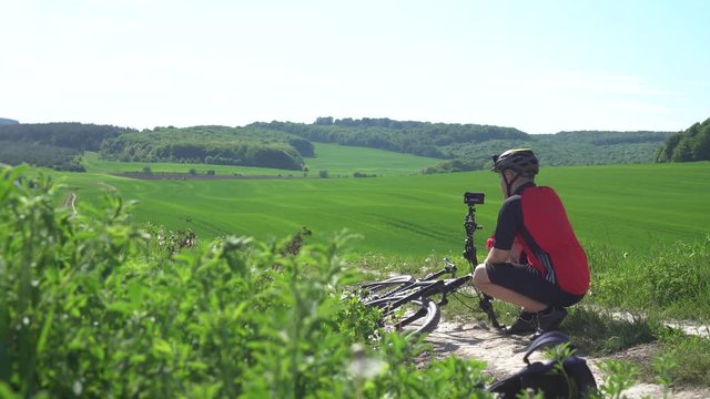 man on a bicycle takes video at the camera