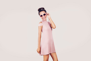 Fashion girl with pink dress isolated on white