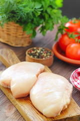 Raw chicken fillet with spices and vegetables