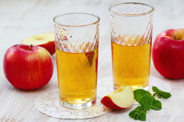 Apple juice and apples on the table