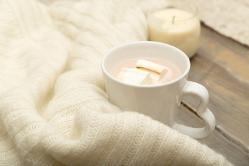 Fototapeta na wymiar Hot chocolate, marshmallow, knitted, warm plaid on a wooden background