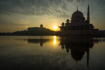 PUTRAJAYA, MALAYSIA - 16TH APRIL 2017; Sunrise moment at Putra Mosque, a principal mosque of Putrajaya, Malaysia. Construction of the mosque began in 1997 and was completed two years later.