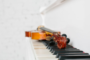 The violin and keyboard of white piano