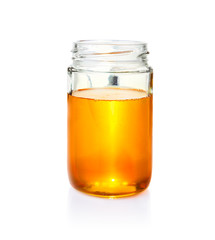 honey in glass jar on white bacground