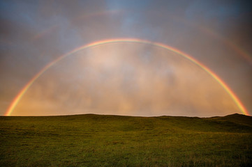 Fototapeta na wymiar Double rainbow on a field