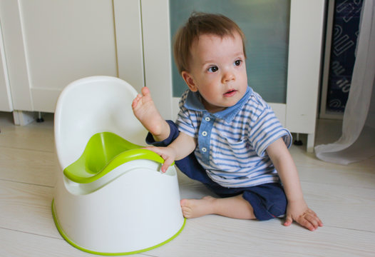 A little boy learns to go potty. Accustom the child to the potty..