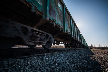 Obraz premium Freight train passing by. Nature landscape. Blurry / fast moving.