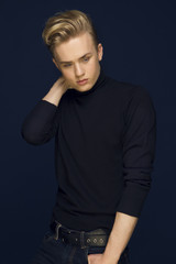 Naklejka premium Attractive young guy posing in studio, blond hair