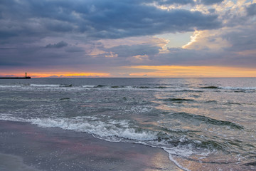 Obraz premium Sunset over Baltic sea. Summer landscape of polish sea with dramatic moody sky.