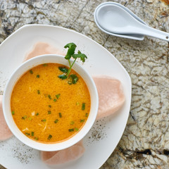 Creamy crab soup served with crab chips and glass of white wine on marble backround. Top view or flat lay.