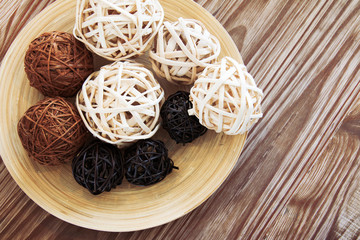 Rattan ball on wooden plate for decoration.