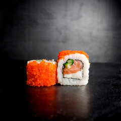 Sushi rolls on black background. Japanese food