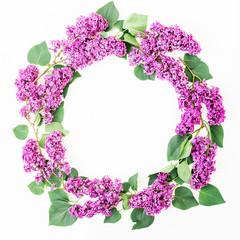 Round floral frame of lilac branches and leaves on white background. Flat lay, top view. Summer pattern