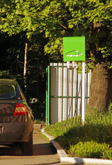 Refueling for an electric car. Charging electric car. Green power car.