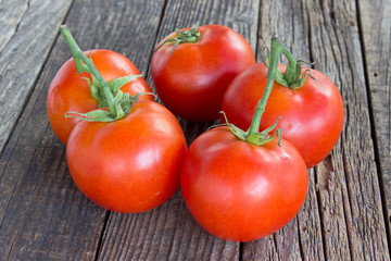 Tomatoes on old wooden background
