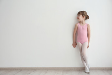 Naklejka premium Cute little ballerina in dance studio