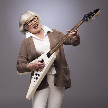 Senior Woman Playing Electric Guitar