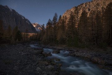 Mountain river on the background of the evening autumn landscape