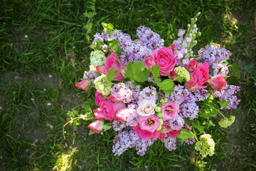 Obraz na płótnie Canvas Beautiful blooming bouquet of festive flowers on grass in garden