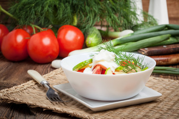 Fresh salad in white bowl.