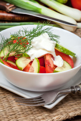Fresh salad in white bowl.