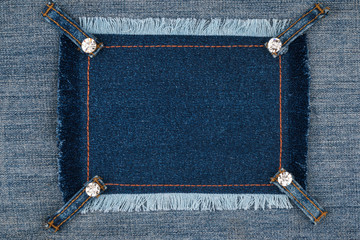 Denim frame with fringe and four belts with rhinestones.