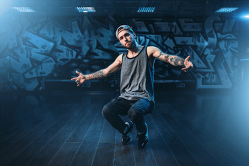 Male rapper in dance studio, trendy lifestyle - obrazy, fototapety, plakaty
