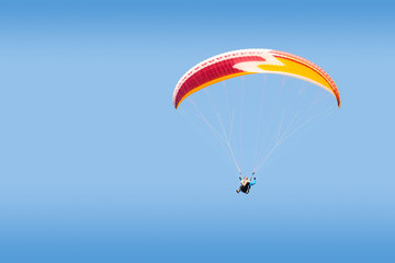 Tandem paraglider free gliding in deep blue sky