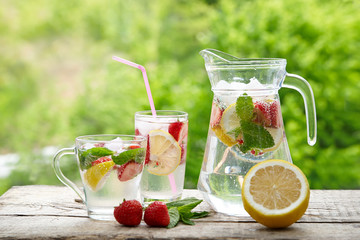 Cold summer drink with mint, strawberry and lemon