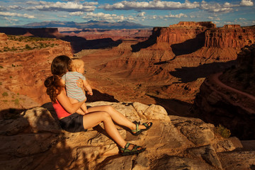 A mother and her baby son visit Canyonlands National park in Utah, USA