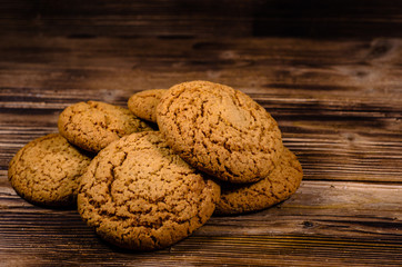 Stack of the oatmeal cookies on wooden table